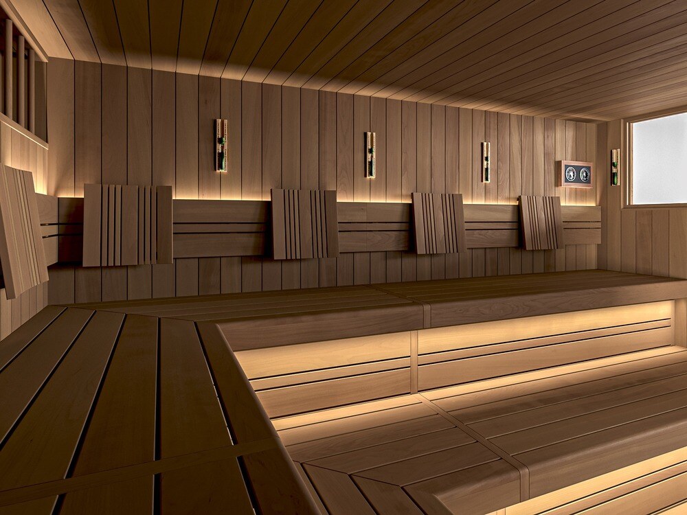 A long public sauna by DWILD with tiered wooden benches lit from below and wooden backrests along the wall