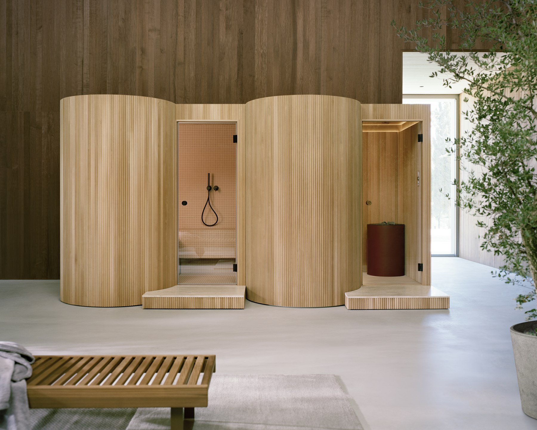 Light linden Baluar hammam and sauna side by side, with curved ribbed exteriors and open glass doors