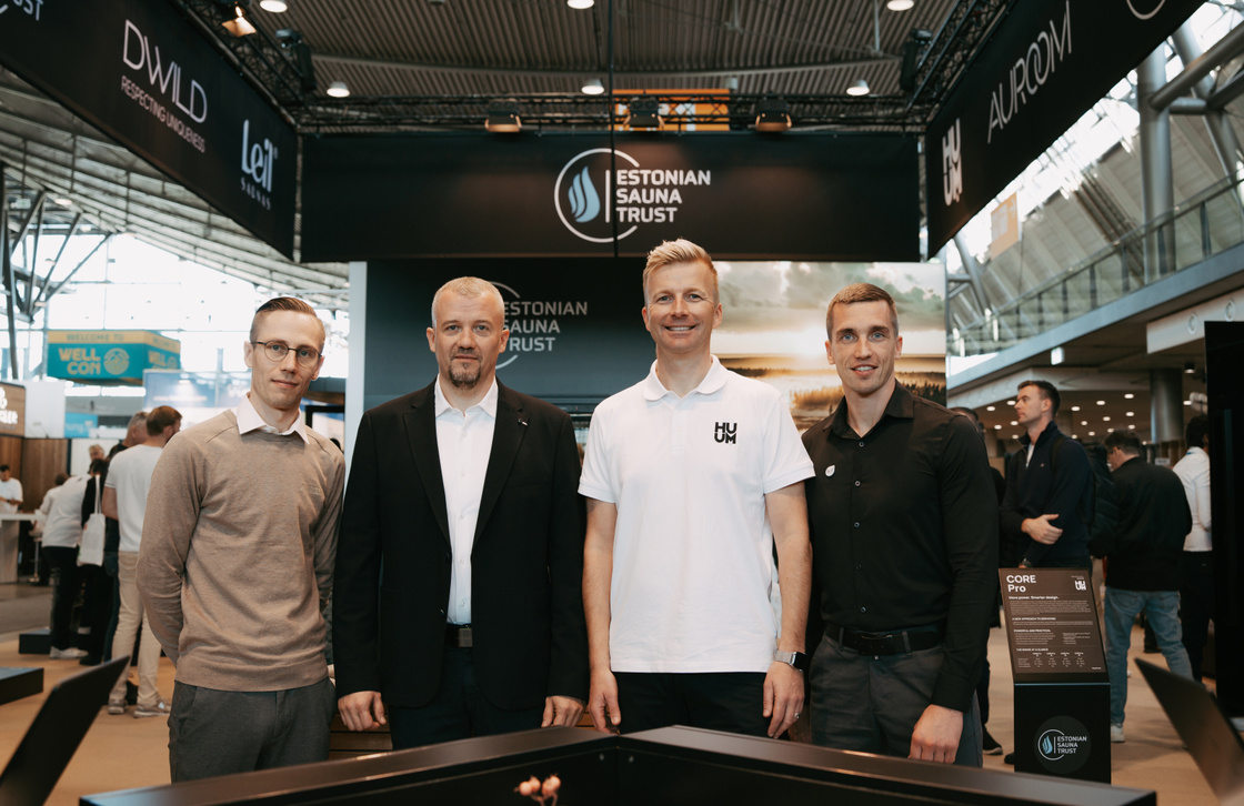 Four men standing in front of the Estonian Sauna Trust stand at Interbad 2026, under banners for DWILD, Leil, HUUM and Auroom