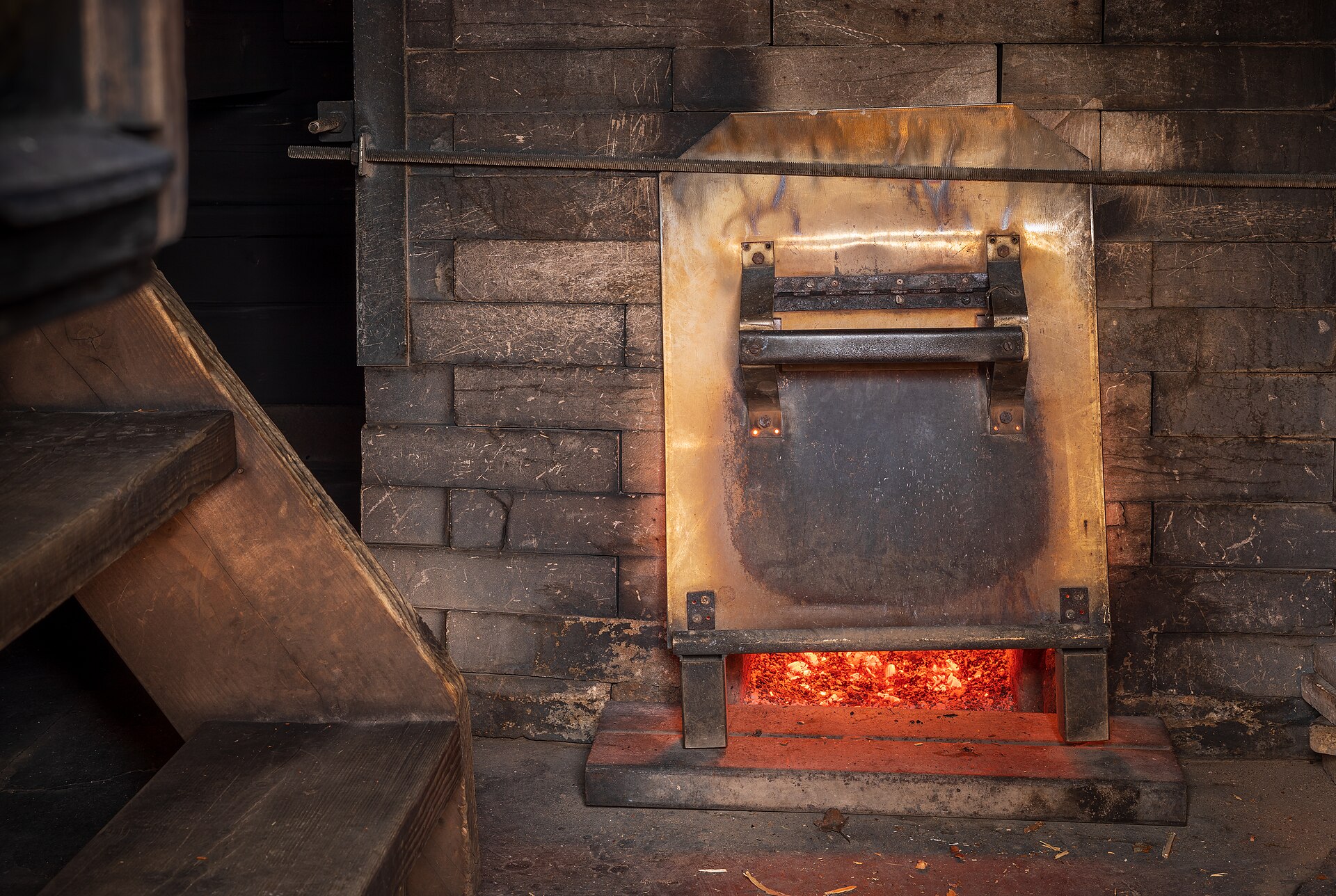 Wood fire burning down inside the masonry firebox of a Finnish smoke sauna at Kuusijärvi, Vantaa