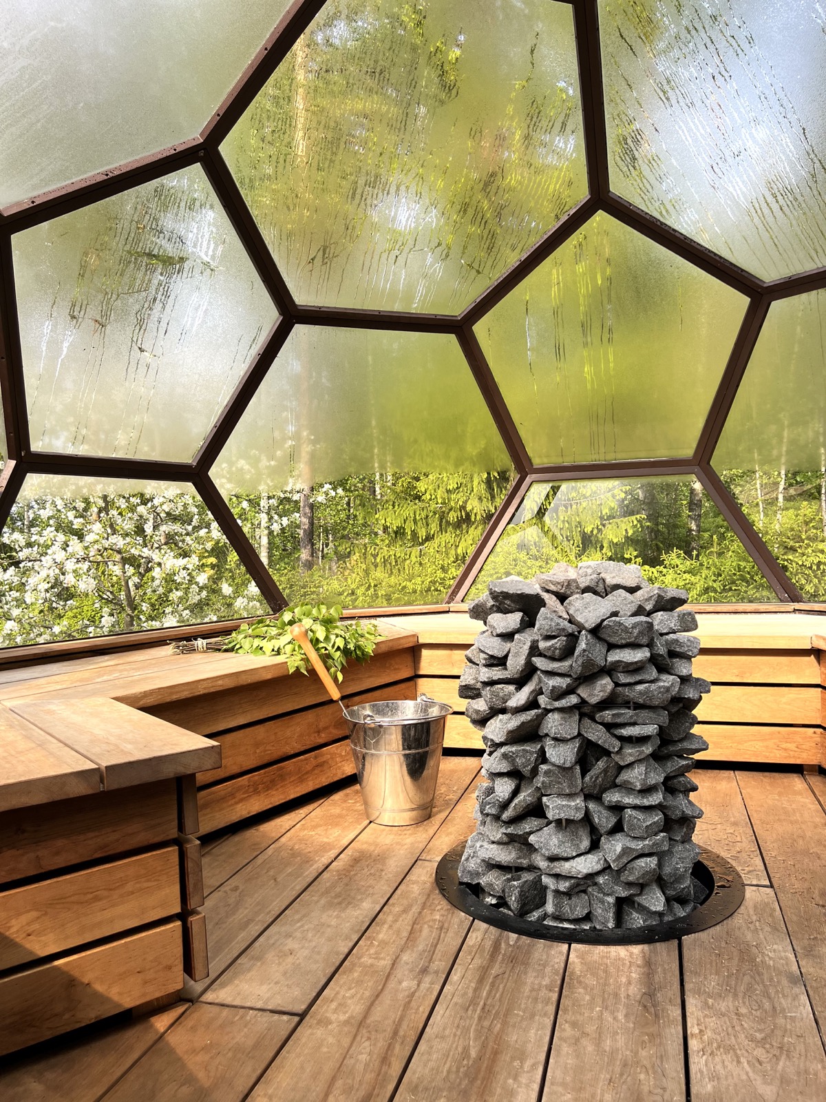 Mondex Rakka all-stone sauna heater inside a glass-fronted Finnish sauna
