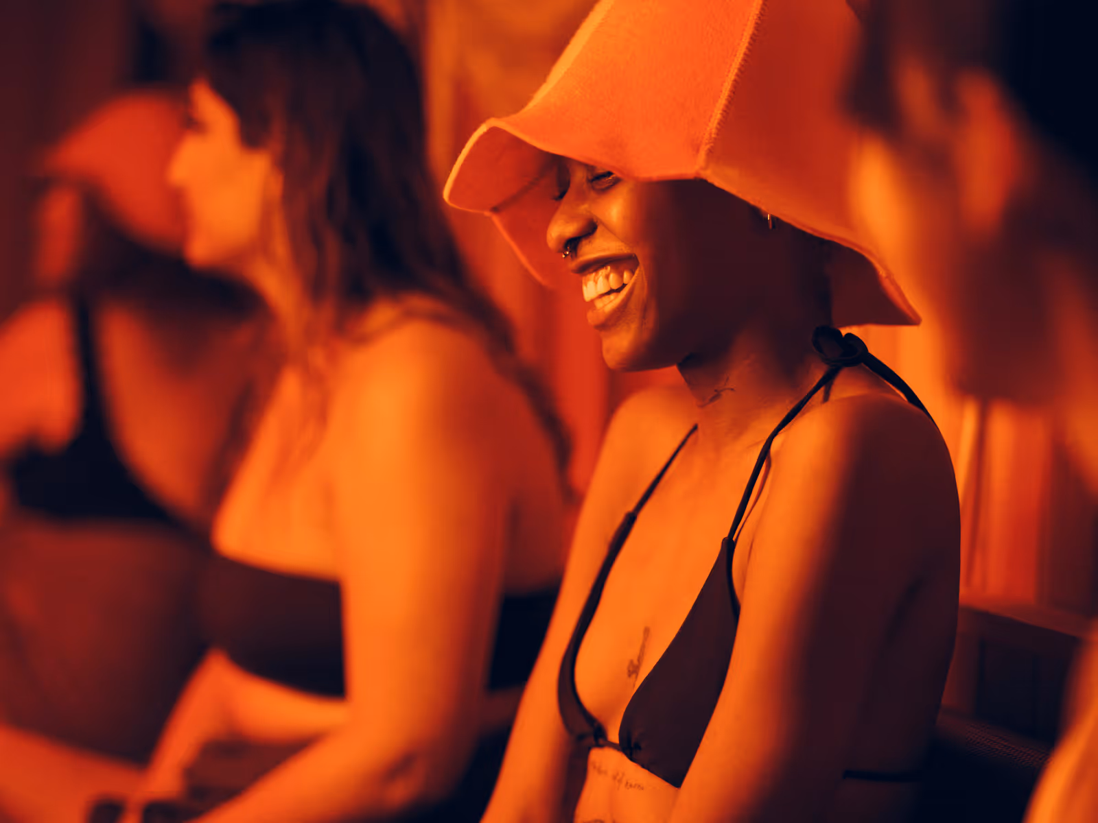 Guests talk in warm lighting at Othership Yorkville’s social commons.