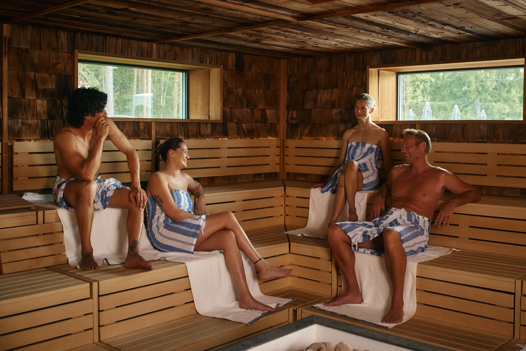 Timber benches and treetop windows in The Well's Forest Sauna