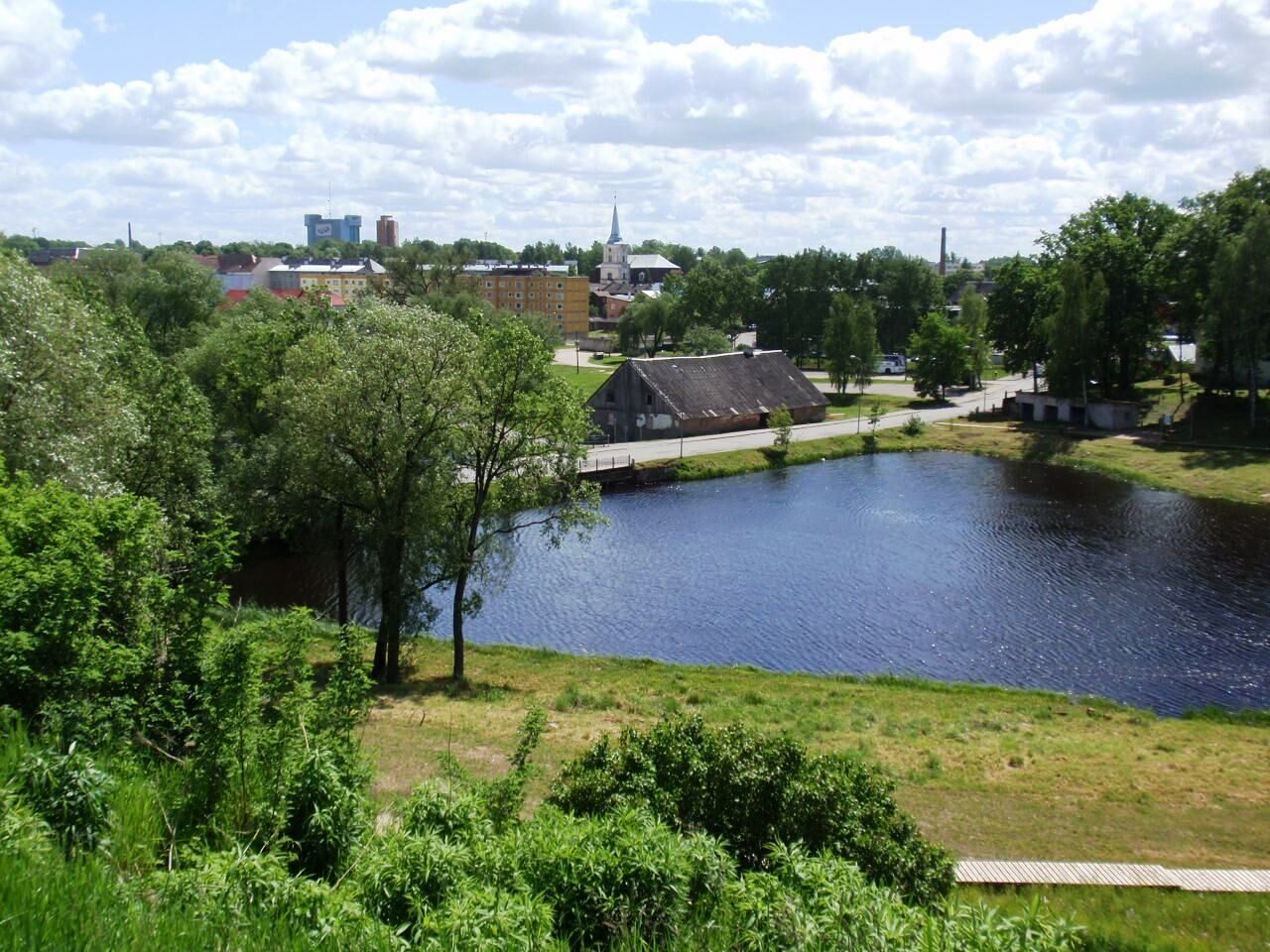 View across the Pedeli river toward the centre of Valga, Estonia, with the church spire visible